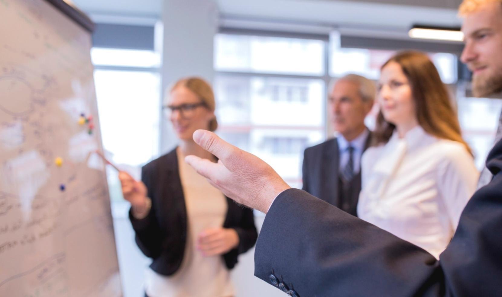 Investment professionals analyzing market data and portfolio performance during a strategy meeting