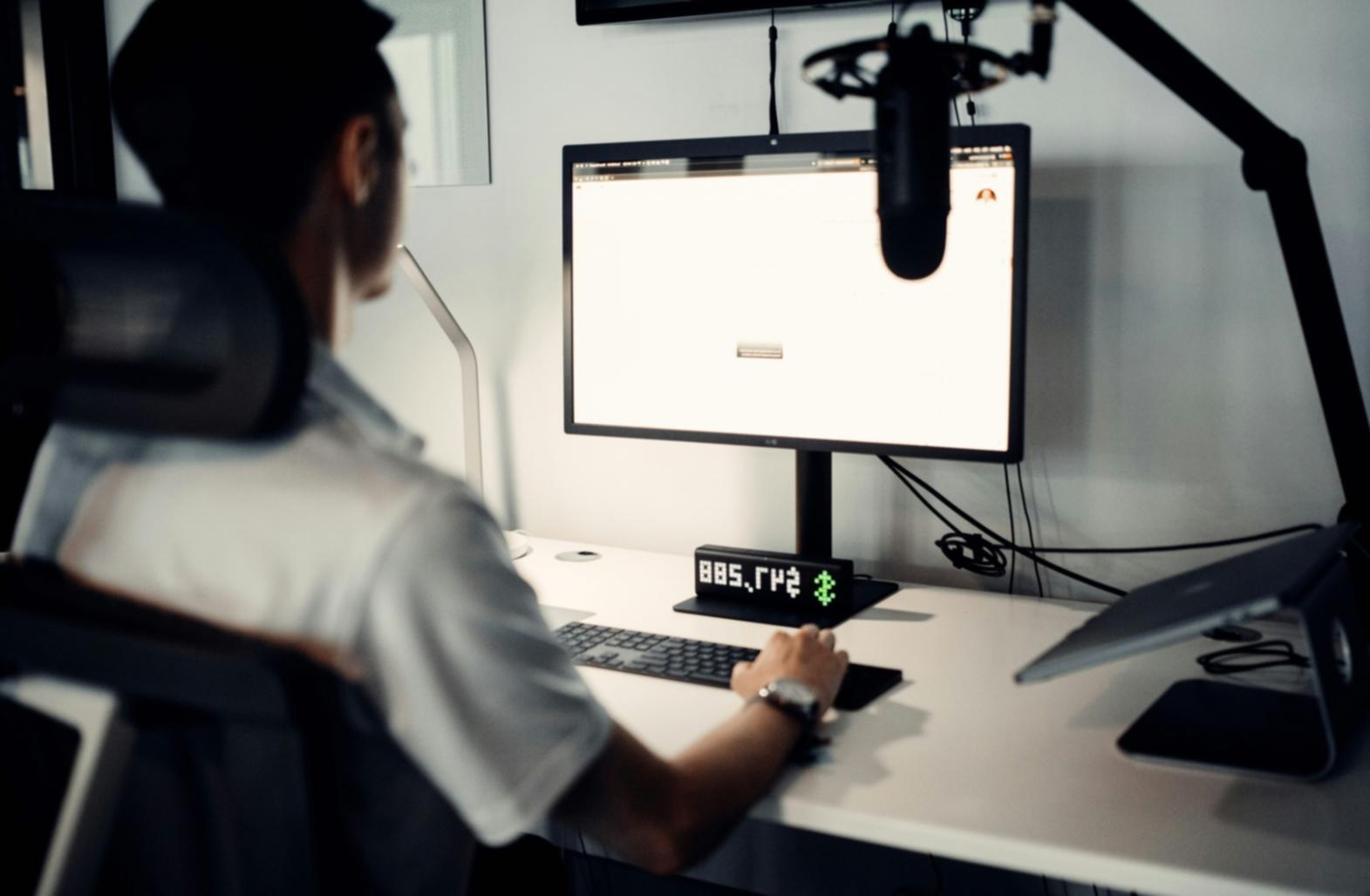 Modern quantitative finance office environment with team members analyzing market data and developing investment algorithms